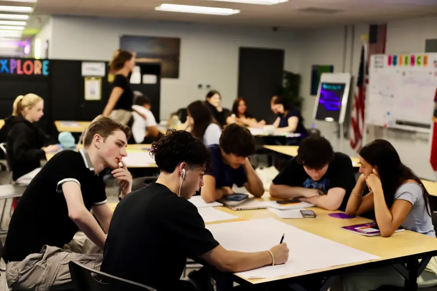 Students working together at long tables