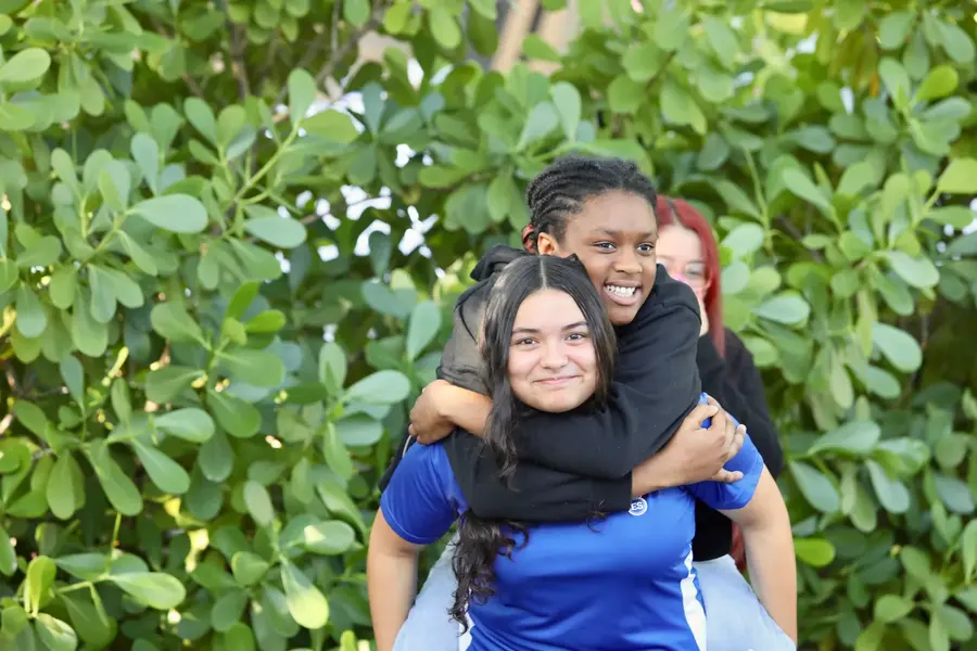 Two friends hugging outdoors