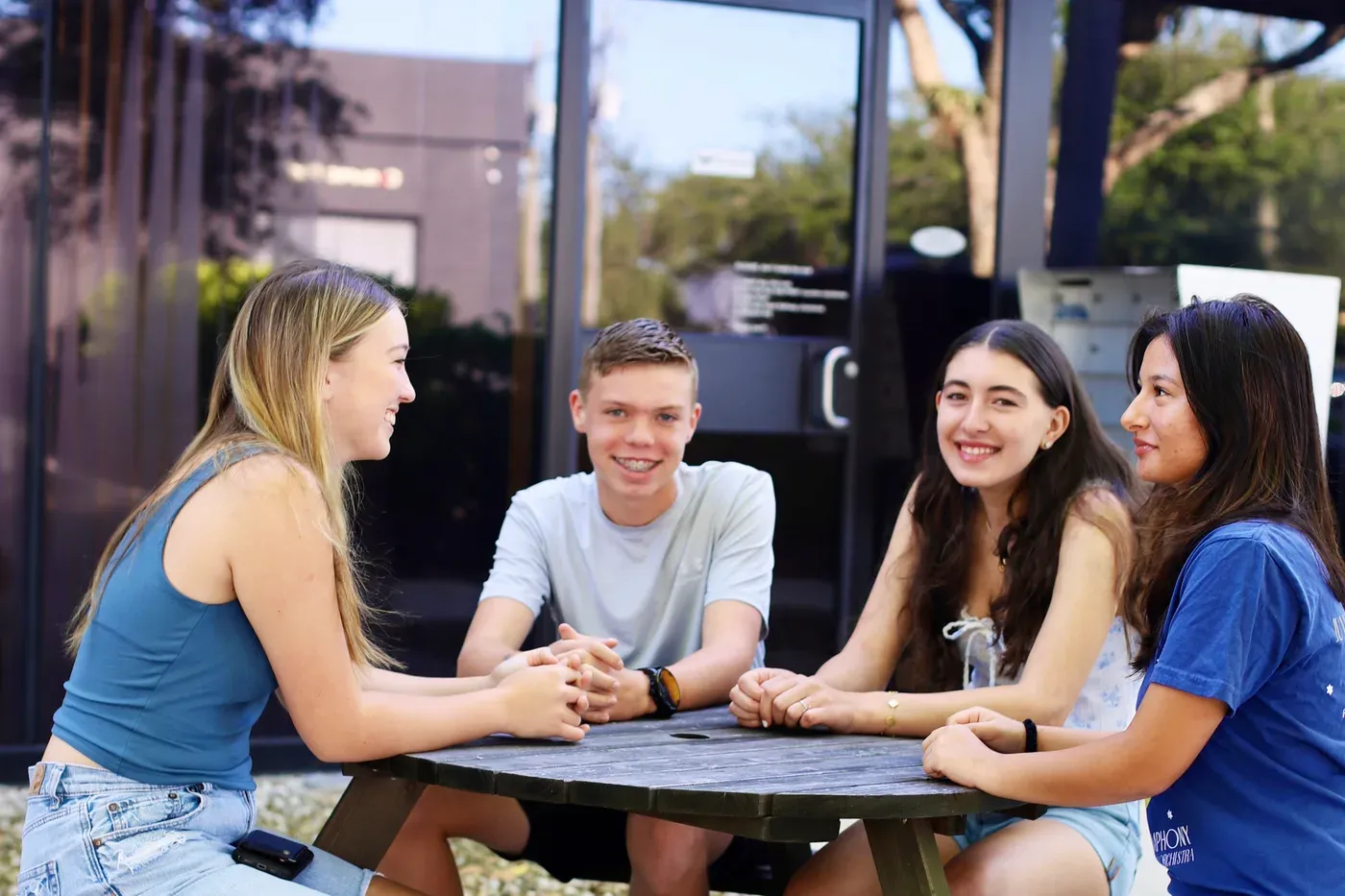 Freedom students laughing together outside the Naples campus
